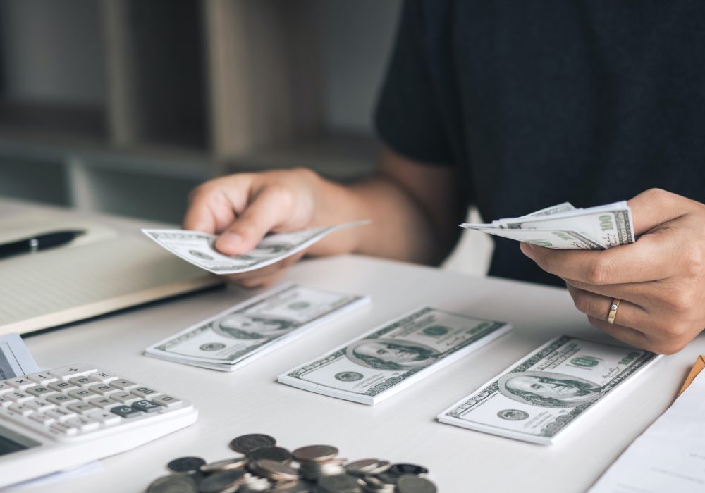 asian-men-are-holding-banknotes-in-cash-and-placed-on-the-table-with-the-idea-of-saving-money-.jpg